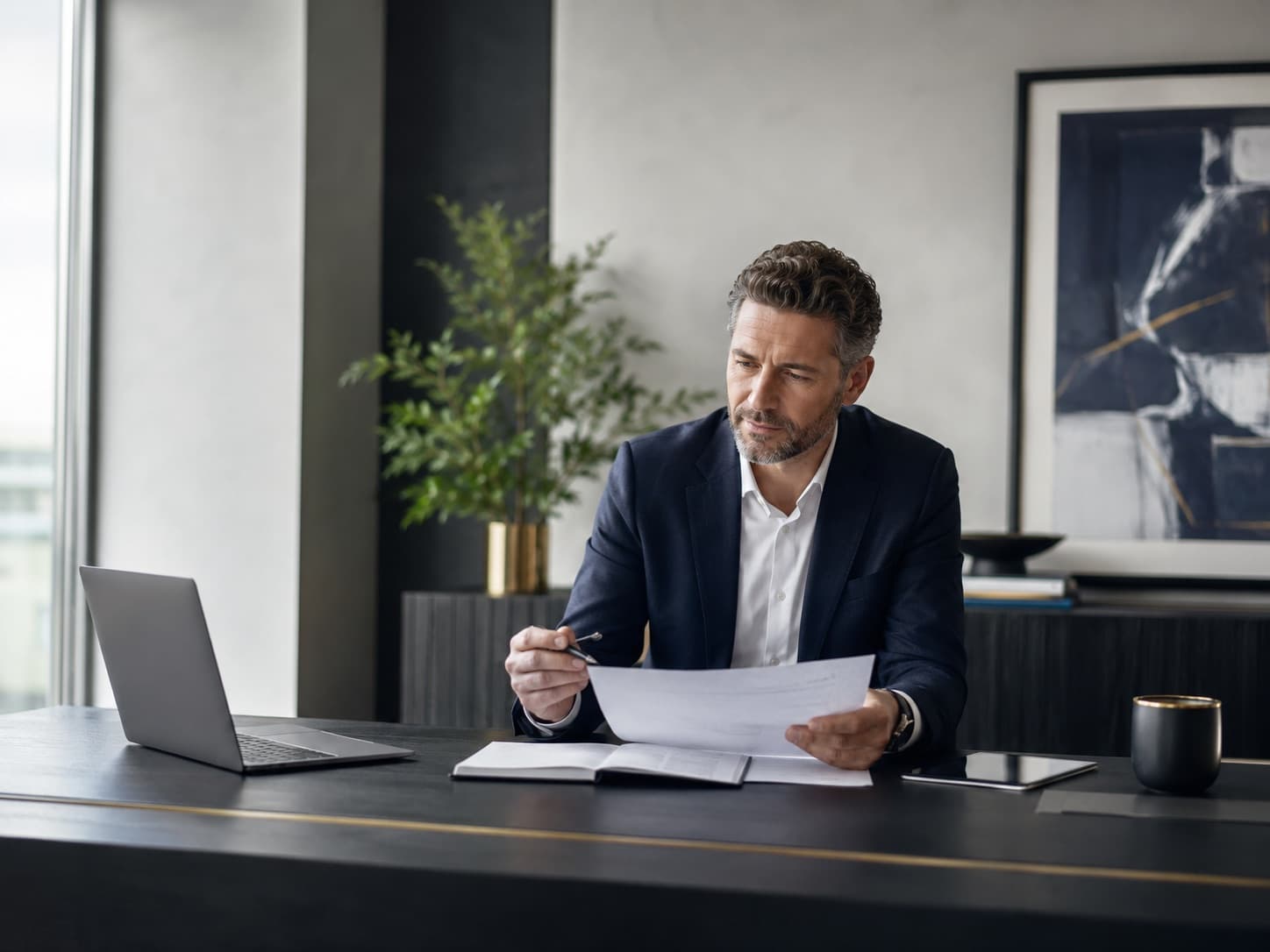A business owner reviewing a document at their desk